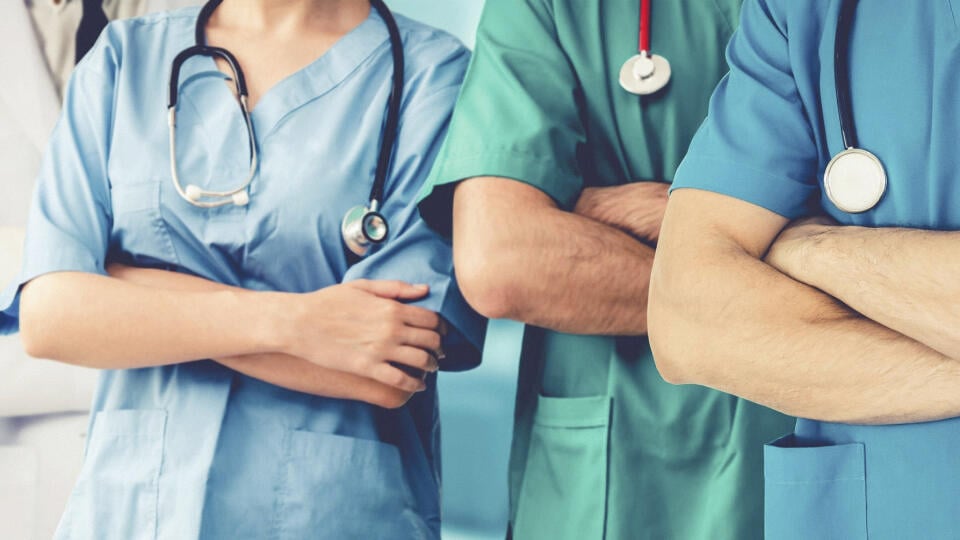 Doctor working in hospital to fight 2019 coronavirus disease or COVID-19. Professional healthcare people with other doctors, nurse and surgeon. Corona virus medical care and protection concept.