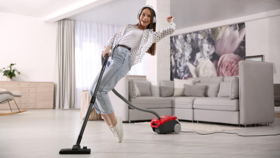 Young,Woman,Having,Fun,While,Vacuuming,At,Home