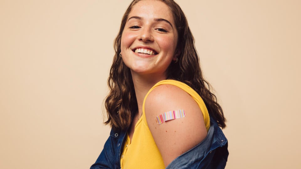 Portrait,Of,A,Female,Smiling,After,Getting,A,Vaccine.,Woman