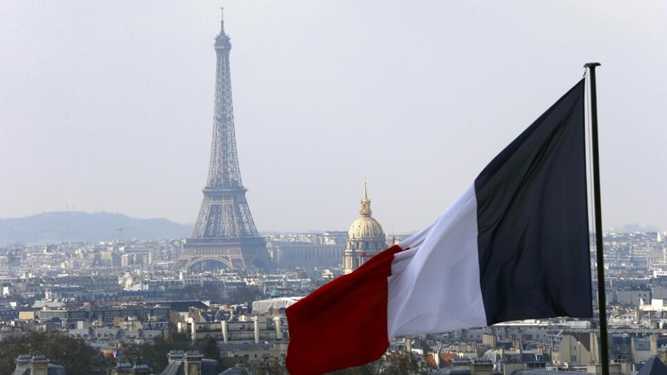 file - In this April 1, 2016 file photo, the French flag above the skyline of the French capital with the Eiffel Tower, The Invalides Dome and roof tops are seen from the colonnade of the Pantheon Dome in Paris. The Eiffel Tower, normally open every day of every year, is closed Tuesday Dec.13, 2016 because of a strike over salaries and working conditions. (AP Photo/Francois Mori)