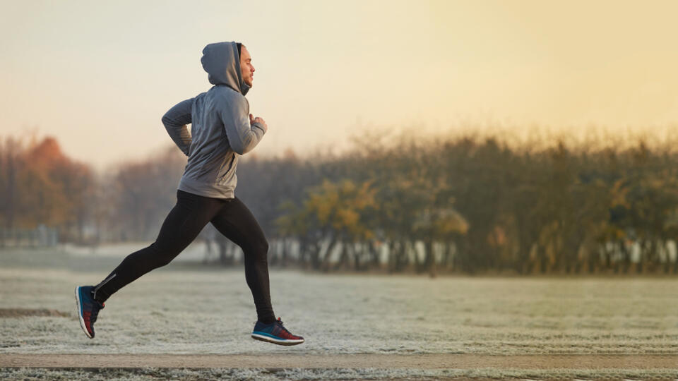 Young,Athletic,Man,Running,At,Park,During,Cold,Autumn,Morning