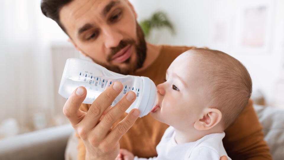 Fatherhood.,Young,Father,Giving,His,Little,Baby,Toddler,Bottle,Of