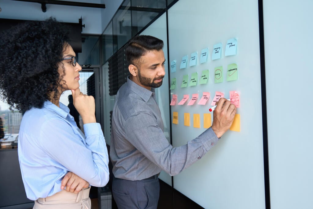 Young,Indian,Businessman,Manager,Writing,Strategy,Ideas,On,Sticky,Notes