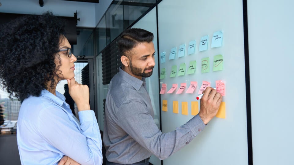 Young,Indian,Businessman,Manager,Writing,Strategy,Ideas,On,Sticky,Notes
