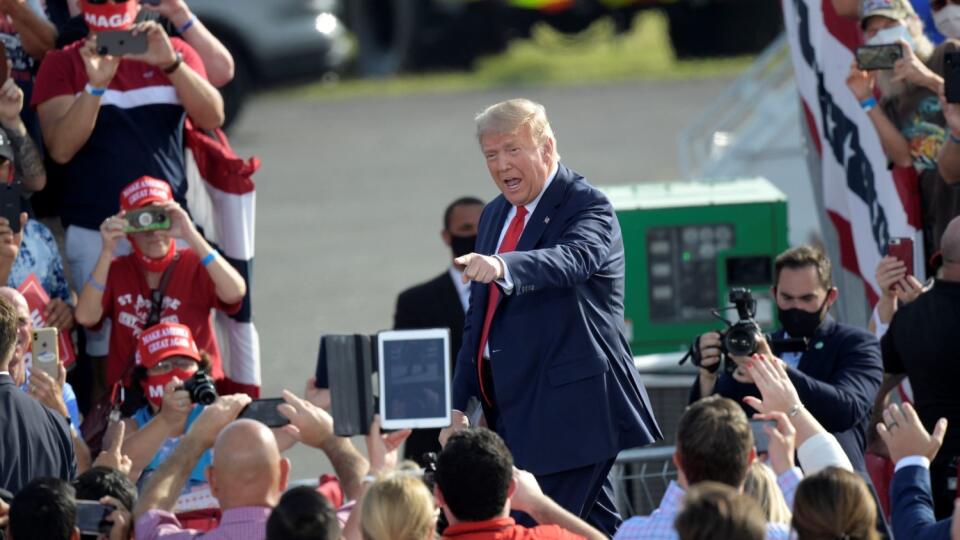 President Donald Trump points to supporters after arriving for a campaign rally at the Ocala International Airport, Friday, Oct. 16, 2020, in Ocala, Fla.