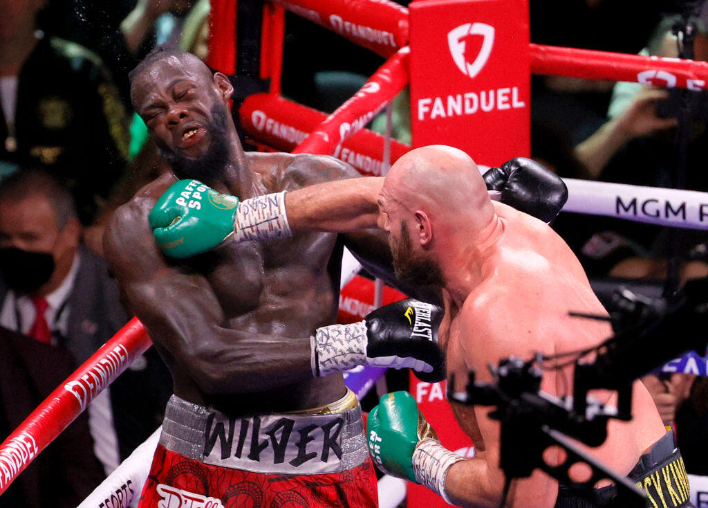LAS VEGAS, NEVADA - OCTOBER 09: Tyson Fury (R) hits Deontay Wilder in the eighth round of their WBC heavyweight title fight at T-Mobile Arena on October 9, 2021 in Las Vegas, Nevada. Fury retained his title with an 11t-round knockout. (Photo by Ethan Miller/Getty Images)