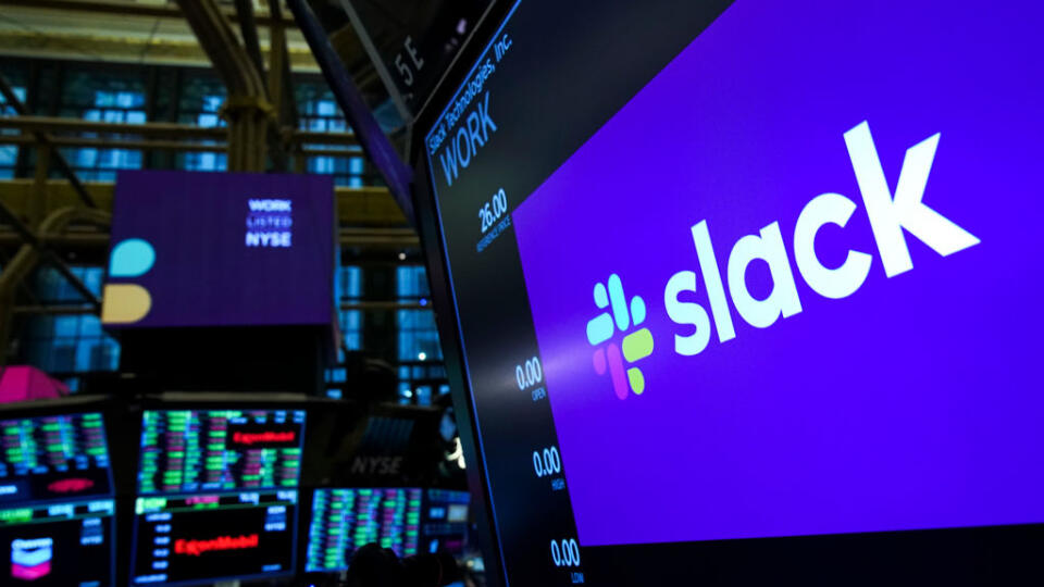 NEW YORK, NY - JUNE 20: The logo for Slack is displayed on a trading post monitor at the New York Stock Exchange (NYSE), June 20, 2019 in New York City. The workplace messaging app Slack will list on the New York Stock Exchange this morning. Shares of Slack were surging more than 60 percent over its reference price in early afternoon trading. (Photo by Drew Angerer/Getty Images)