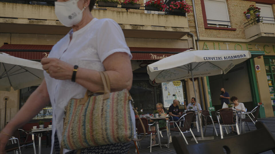 WA 53 Pamplona - Žena s ochranným rúškom kráča okolo ľudí sediacich v bare v severošpanielskom meste Pamplona v pondelok 5. júla 2021. FOTO TASR/AP
A woman with a face covering walks past customers at a bar, in Pamplona, northern Spain, Monday, July 5, 2021. (AP Photo/Alvaro Barrientos)