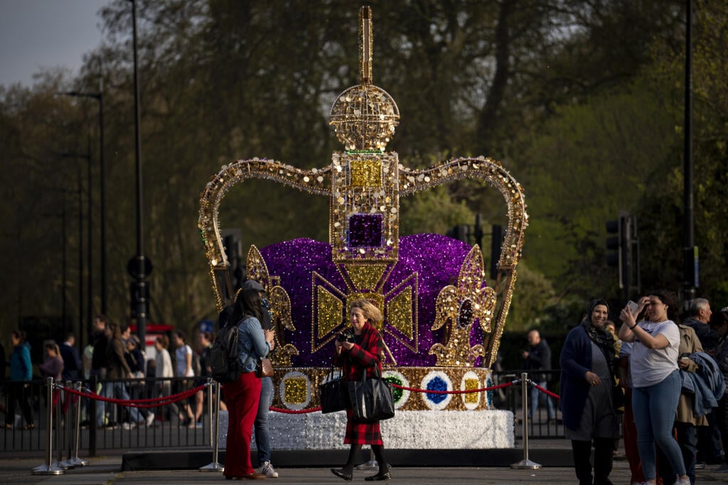 WA 19 Лондон. Люди проходят мимо художественной инсталляции с изображением короны Святого Эдуарда в центре Лондона во вторник, 3 мая 2023 года. Коронация британского короля Карла III. и его жены Камиллы состоится в Вестминстерском аббатстве в субботу, 6 мая. Историческая корона Святого Эдуарда была центральным элементом коронации монархов в Англии на протяжении более 350 лет. Корона обычно является частью драгоценностей короны, выставленных в лондонском Тауэре. ФОТО TASR/AP Люди идут рядом с арт-инсталляцией