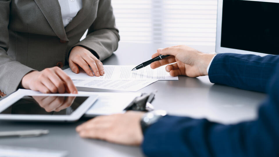 Business,People,And,Lawyer,Discussing,Contract,Papers,Sitting,At,The