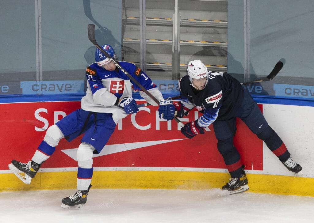 Americký hokejista Brock Faber (11) a slovenský hokejista Rayen Petrovický (12) vo štvrťfinále MSJ USA 20 - Slovensko 20, v kanadskom Edmontone 2. januára 2021.