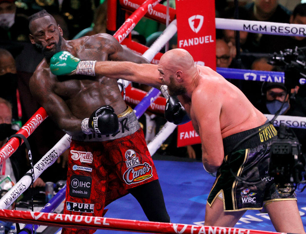 LAS VEGAS, NEVADA - OCTOBER 09: Tyson Fury (R) hits Deontay Wilder in the seventh round of their WBC heavyweight title fight at T-Mobile Arena on October 9, 2021 in Las Vegas, Nevada. Fury retained his title with an 11t-round knockout. (Photo by Ethan Miller/Getty Images)