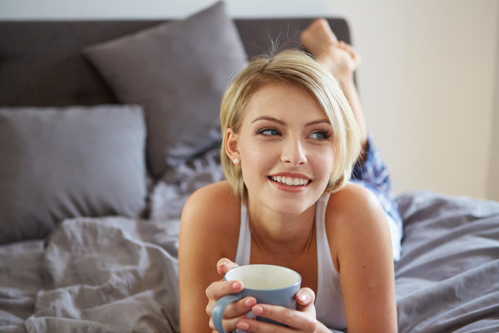 Happy,Smiling,Beautiful,Blond,Woman,Awaking,With,Cup,Of,Coffee