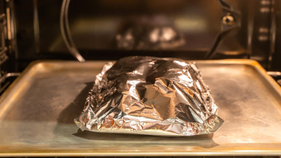 Food,Covered,With,Foil,On,The,Pan,Inside,Gas,Oven