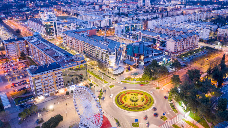 Podgorica Montenegro in the evening. Night cityscape of the capital of a small country in the Balkans, south east Europe. Traffic on roundabout in residential and commercial city center. Aerial view.