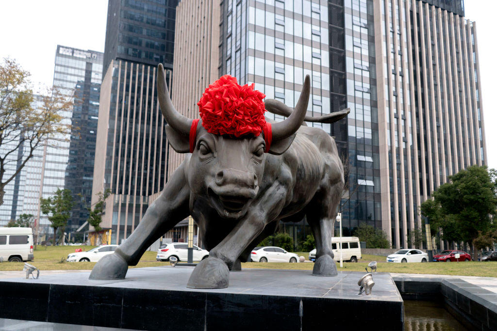 A bronze Bull sculpture stands at the financial district of