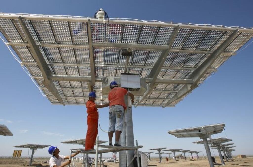 Robotníci inštalujú solárne panely na stavenisku fotovoltaickej elektrárne v Cha-mi v čínskej Ujgurskej autonómnej oblasti.