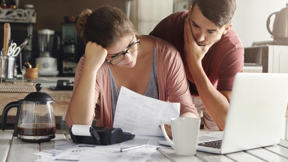 Young,Stressed,Caucasian,Couple,Facing,Financials,Troubles,,Sitting,At,Kitchen