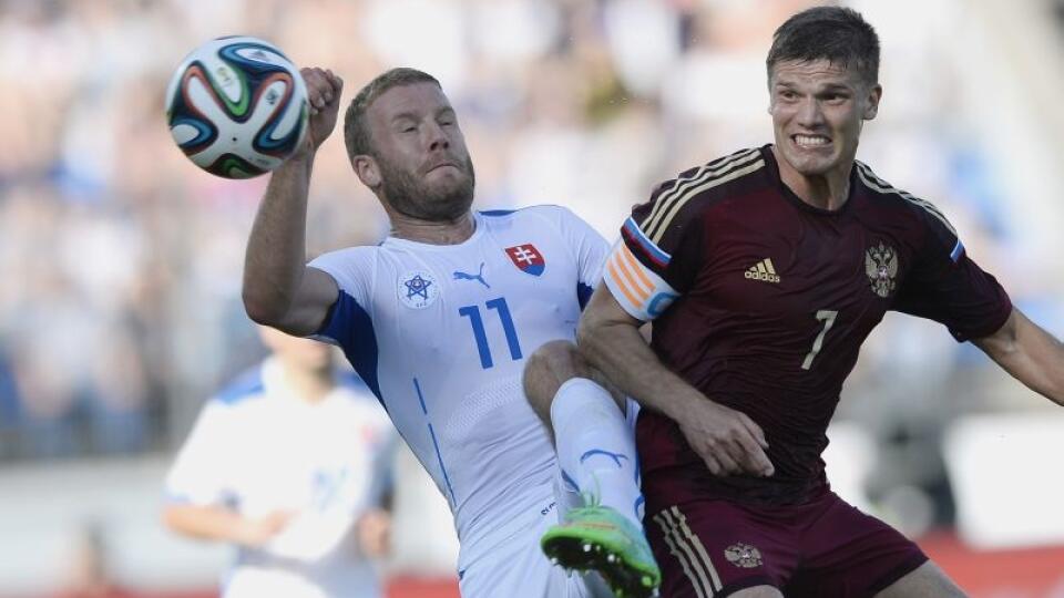Hráč Slovenska Adam Nemec a hráč Ruska Igor Denisov (vpravo) bojujú o loptu v priateľskom futbalovom zápase Rusko - Slovensko v Petrohrade 26. mája 2014. FOTO TASR - Michal Svítok