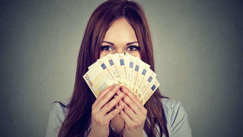 woman hiding her face behind euro money