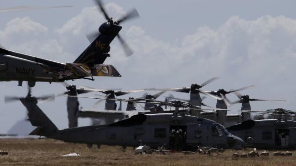 U.S. Navy Osprey and Seahawk helicopters prepare to load relief supplies for air drop to isolated villages at Tacloban airport, Leyte province in central Philippines, Friday Nov. 15, 2013. The Philippines has received an outpouring of international aid running into hundreds of millions of dollars but much of it has been stuck in a bottleneck outside the affected areas. (AP Photo/Bullit Marquez)