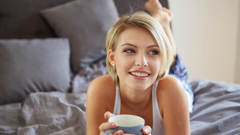 Happy,Smiling,Beautiful,Blond,Woman,Awaking,With,Cup,Of,Coffee