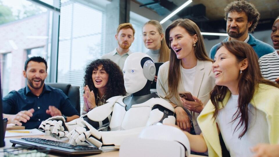 Multi-ethnic,Group,Of,Smart,Engineers,Looking,At,Their,Robot,Entering