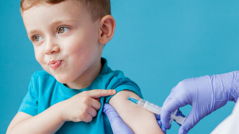 Vaccination,Concept.,Female,Doctor,Vaccinating,Cute,Little,Boy,On,Blue