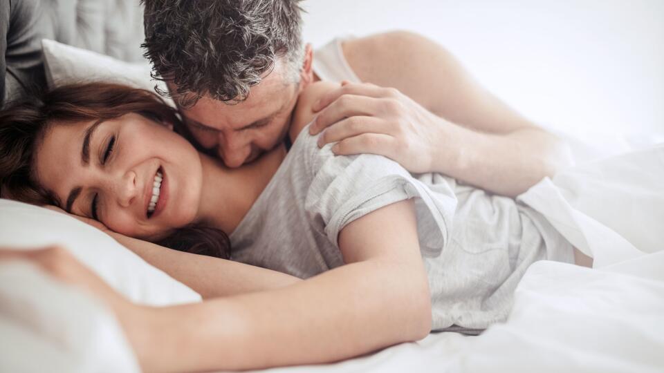 Beautiful passionate couple having sex on bed.