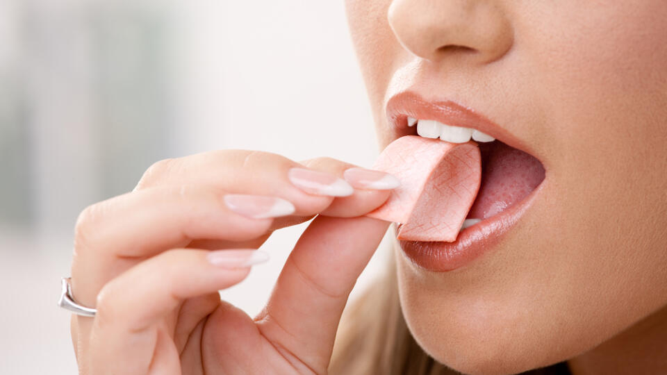 Closeup,Detail,Of,Woman,Putting,Pink,Chewing,Gum,Into,Her