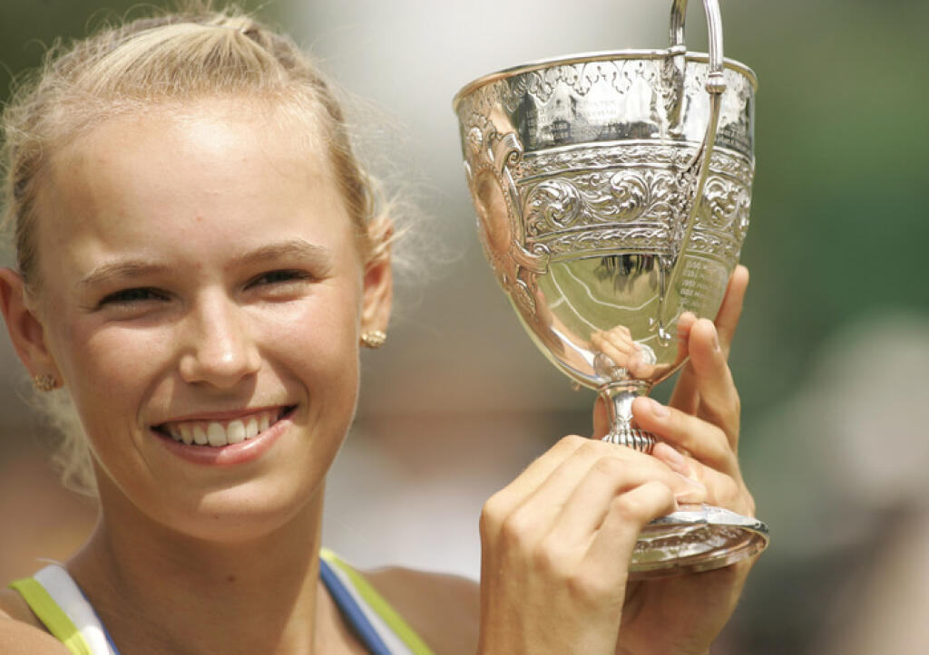 Denmark's Caroline Wozniacki holds the Girl's Championship trophy after her 3-6, 6-1, 6-3 win over Magdalena Rybarikova of Slovakia after their Girl's Singles final at Wimbledon, Saturday, July 8, 2006. (AP Photo/Alastair Grant)