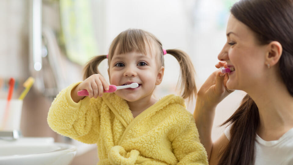 Beautiful,Mother,And,Kid,Daughter,Brushing,Teeth,In,Bathroom