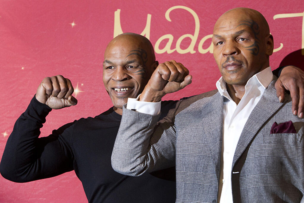 Former heavyweight boxing champion Mike Tyson, left, poses with the world's first Mike Tyson wax figure during the figure's unveiling at Madame Tussauds Las Vegas in Las Vegas, Tuesday, Dec. 1, 2015. The figure is modeled after Tyson's appearance as himself in