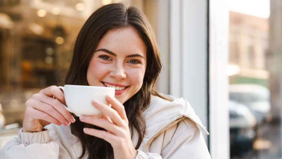 Cheerful,Young,Woman,Having,Tea,With,Cake,At,The,Cafe