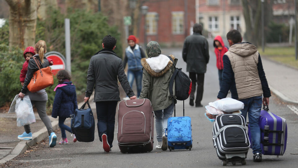 BERLIN, GERMANY - MARCH 11: People pulling suitcases arrive at the Central Registration Office for Asylum Seekers (Zentrale Aufnahmestelle fuer Fluechtlinge, or ZAA) of the State Office for Health and Social Services (Landesamt fuer Gesundheit und Soziales, or LAGeSo), which is the registration office for refugees and migrants arriving in Berlin who are seeking asylum in Germany, on March 11, 2015 in Berlin, Germany. Germany, which registered over 200,000 refugees in 2014, is expecting even mor