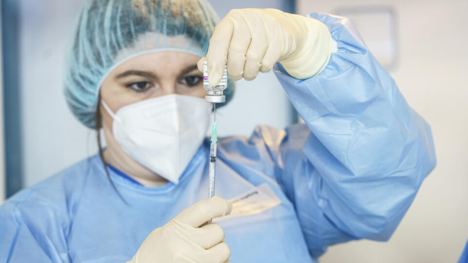 The pharmacist is preparing a syringe with the COVID-19 vaccine from AstraZeneca.