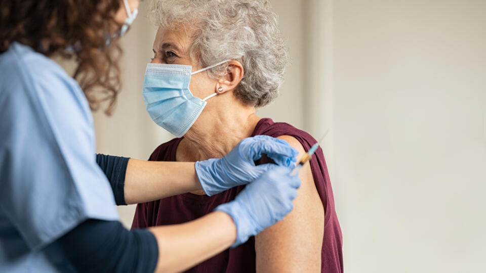 General,Practitioner,Vaccinating,Old,Patient,In,Clinic,With,Copy,Space.