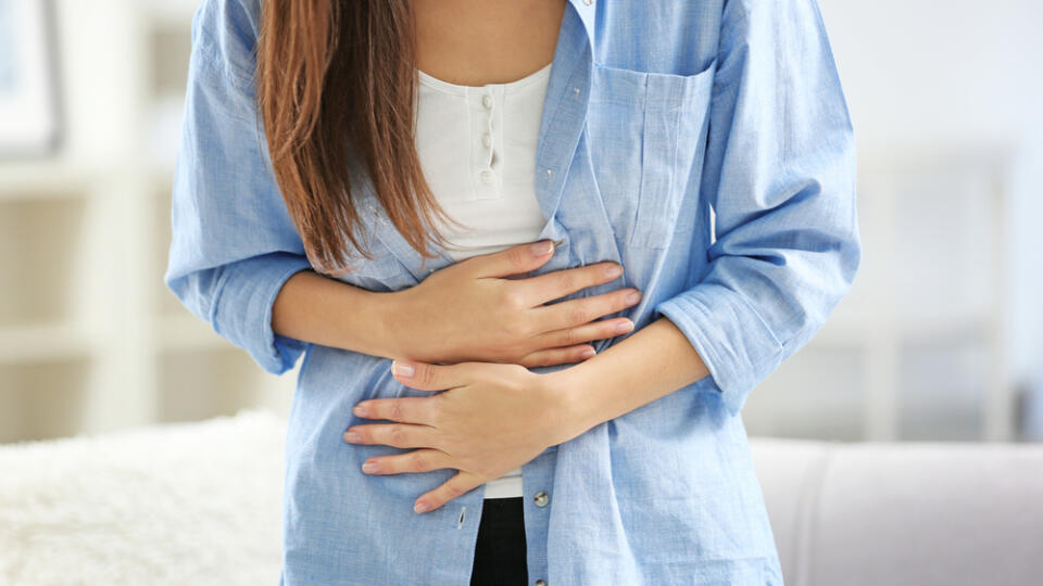 Young,Woman,Suffering,From,Abdominal,Pain,At,Home,,Closeup.,Gynecology