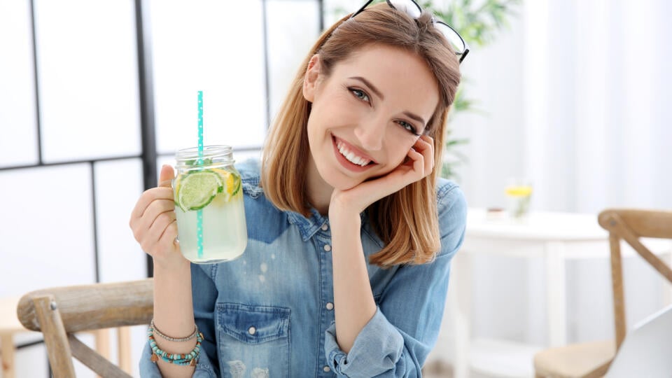 Beautiful,Young,Woman,With,Lemonade,And,Laptop,In,Cafe