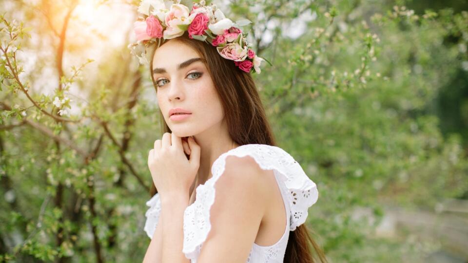 Beautiful girl on the background of spring bush