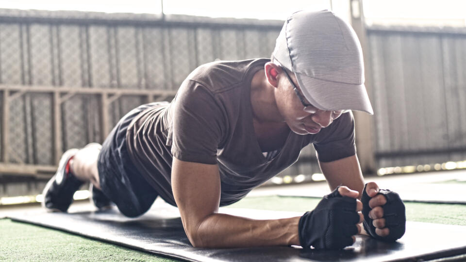 Young,Man,Wearing,Sport,Wear,And,Doing,Plank,Position