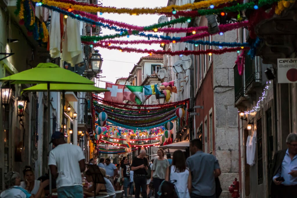 Lisbon, Portugal - CIRCA June, 2019: People in typical Lisbon neighborhood decorated for the popular saints