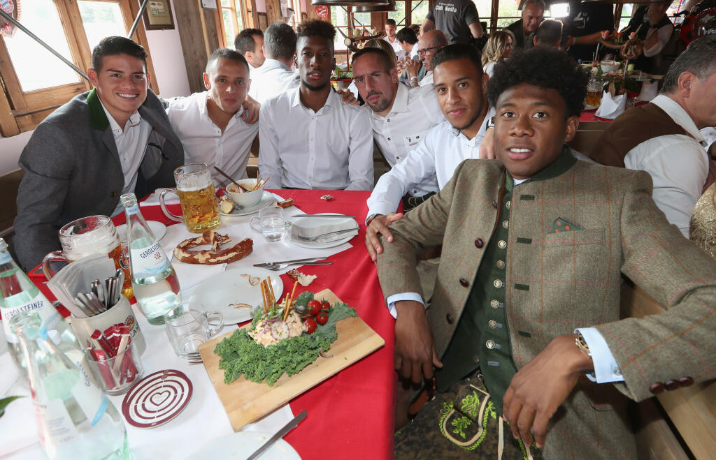 MUNICH, GERMANY - SEPTEMBER 23: James Rodriguez, Rafinha, Kingsley Coman, Franck Ribery, Corentin Tolisso and David Alaba (L-R) of FC Bayern Muenchen attend the Oktoberfest beer festival at Kaefer Wiesenschaenke tent at Theresienwiese on September 23, 2017 in Munich, Germany. (Photo by Alexandra Beier/Bongarts/Getty Images)