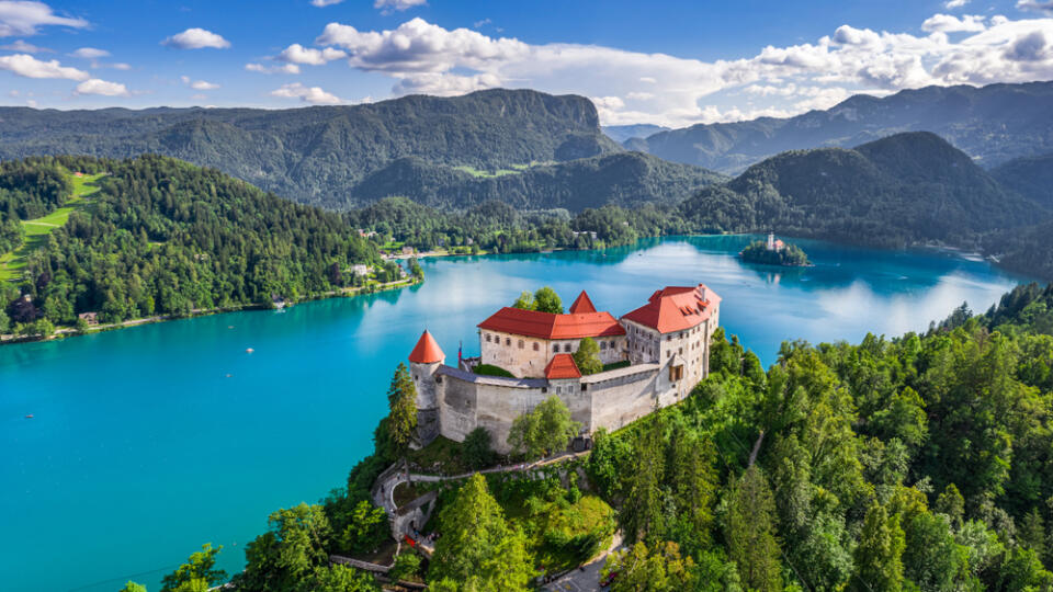 Bled, Slovenia - Aerial panoramic view of beautiful Bled Castle (Blejski Grad) with Lake Bled (Blejsko Jezero), the Church of the Assumption of Maria and Julian Alps at background on a nice summer day