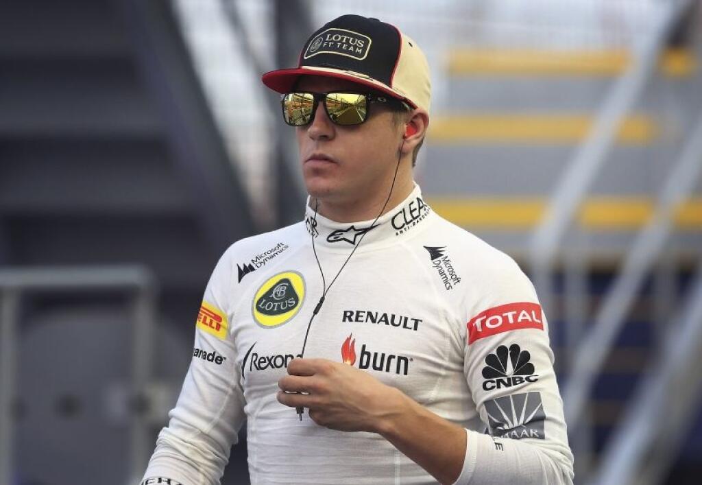 Lotus driver Kimi Raikkonen of Finland walks along the pit lane ahead of the third practice session for the Singapore Formula One Grand Prix on the Marina Bay City Circuit in Singapore, Saturday, Sept. 21, 2013. (AP Photo/Wong Maye-E)