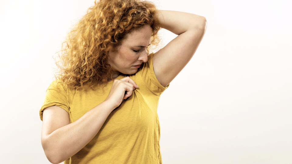 Ginger woman is sweating to much and she doesn't like her smell under armpit.