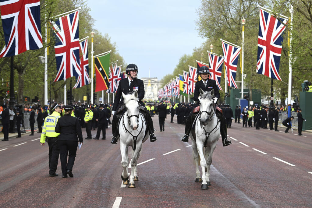 Policemen ride horses on Mall Street before the coronation ceremony of Britain's King Charles III.  and Kamila on May 6, 2023 in London.
