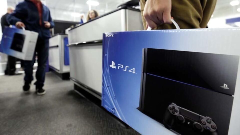 A man holds a Sony Playstation 4 after he purchased it at the Lincoln Park BestBuy store in Chicago on Friday, Nov. 15, 2013. The PlayStation 4, came out Friday. The Xbox One, goes on sale next week. (AP Photo/Nam Y. Huh)