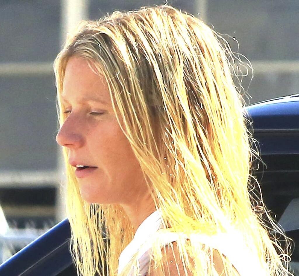 Au naturel no make up rarely seen so Gwyneth Paltrow with wet hair arriving at studio in Culver City is wearing high waist jeans a