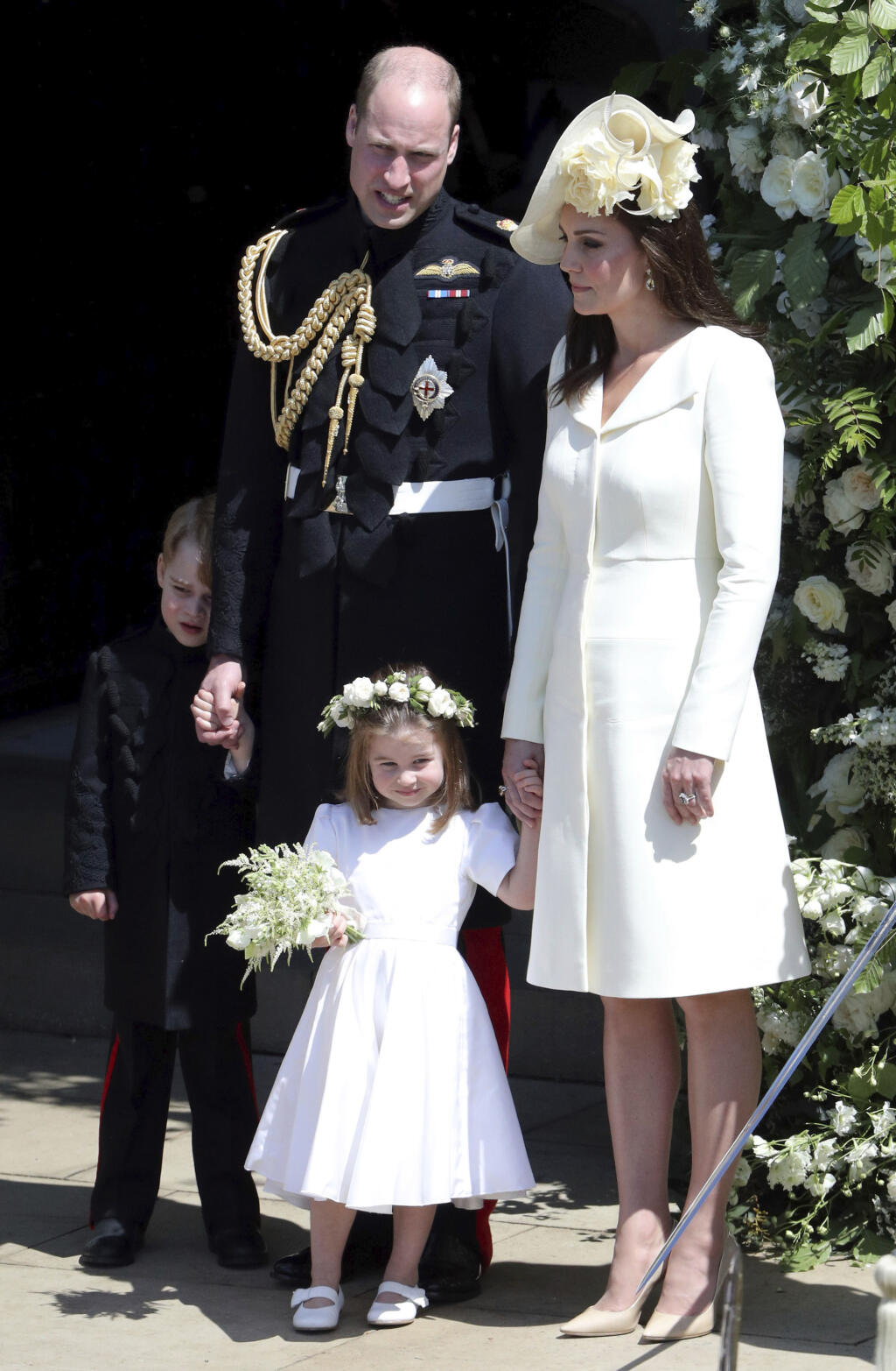 Britain's Prince William and Kate, Duchess of Cambridge with Prince George and Princess Charlotte leave after the wedding ceremony of Prince Harry and Meghan Markle at St. George's Chapel in Windsor Castle in Windsor, near London, England, Saturday, May 19, 2018. (Andrew Matthews/pool photo via AP)